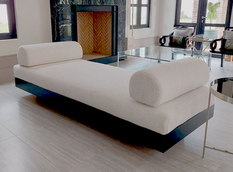 Modern custom daybed with sleek black base and textured white **bespoke upholstery** featuring rounded **custom cushions**, handcrafted by edge.ids in Johannesburg.