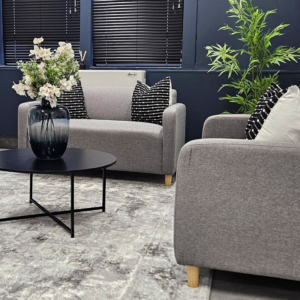 Custom upholstered office seating and curated soft furnishings by edge.ids, featuring patterned scatter cushions and architectural Venetian blinds.