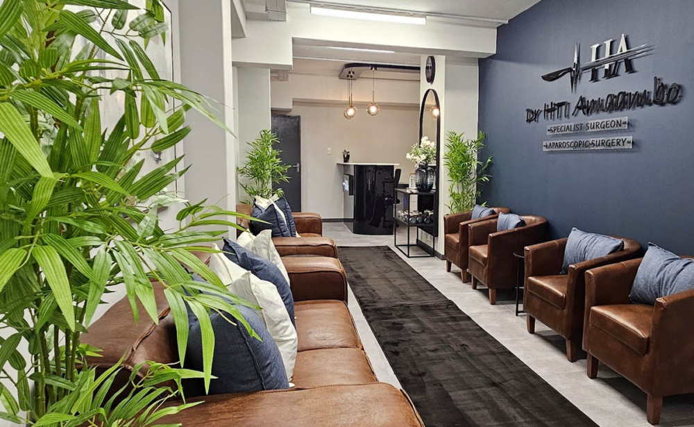 A professional medical suite waiting room featuring leather seating, custom lighting, and a branded reception area designed and styled by edge.ids.