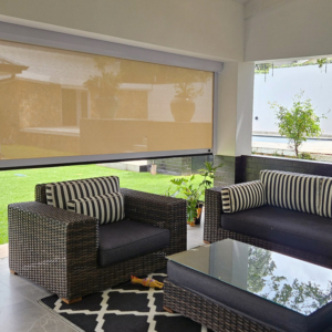 Modern patio entertainment area featuring a wide-span outdoor roller blind for sun protection and light management, curated by edge.ids.