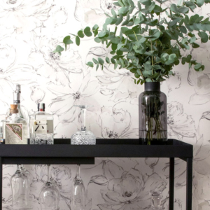 Modern bar cart styling by edge.ids featuring premium glassware and floral wallpaper for a bespoke residential interior design project.